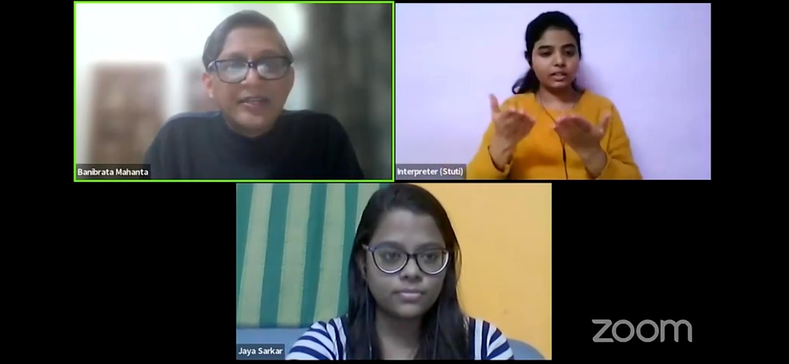 A screenshot from a Zoom meeting showing three participants: Banibrata Mahanta, an interpreter (Stubhi) actively signing, and Jaya Sarkar, each in a separate video frame.