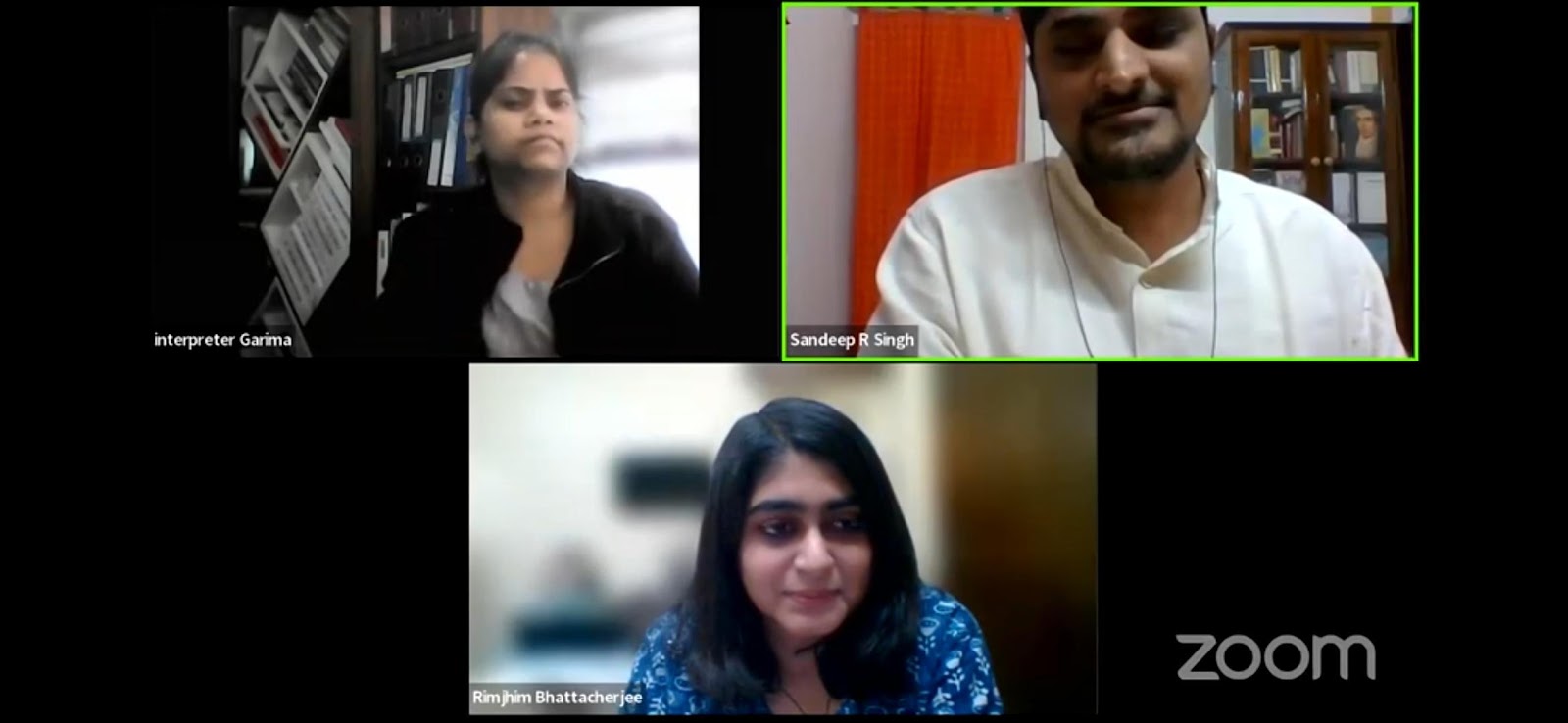 A video call screenshot showing three participants: Interpreter Garima, Sandeep R Singh, and Rimjhim Bhattacherjee, in separate frames against indoor backgrounds.