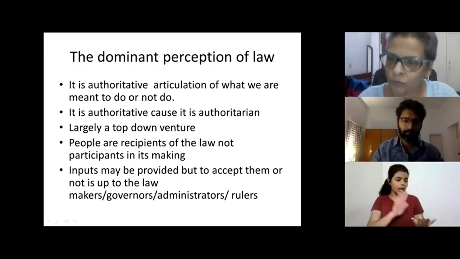 A split-screen view of a video conference, featuring a presentation slide on "The dominant perception of law" and three participants in individual video feeds on the right side.