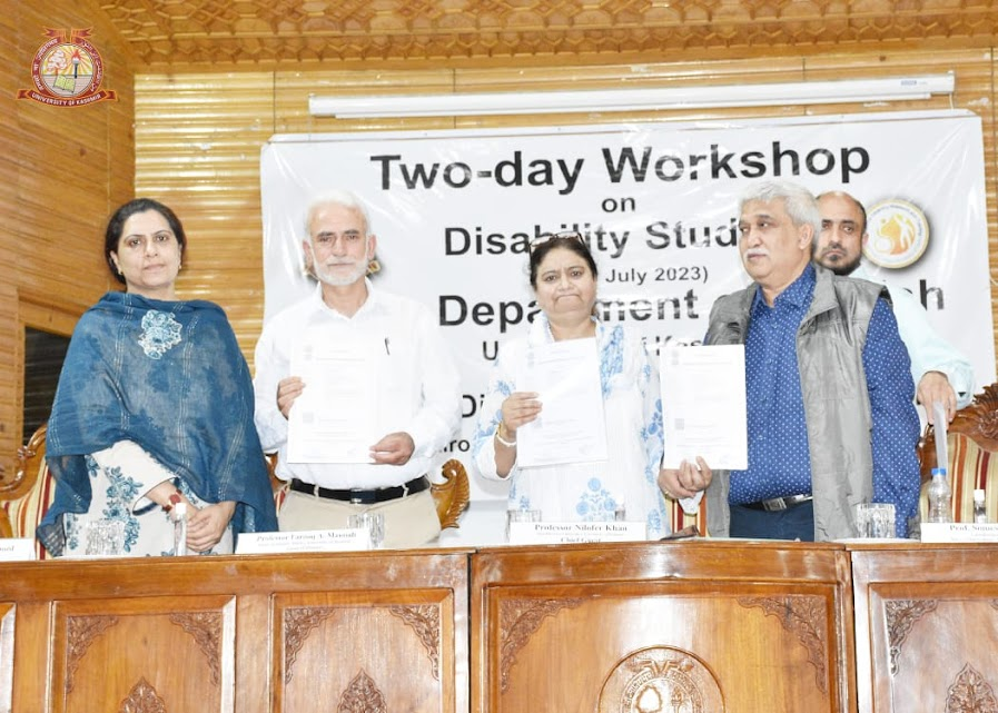 Professors and officials pose with documents at a Two-day Workshop on Disability Studies organized by the Department of Social Work, University of Kashmir, held in July 2023.