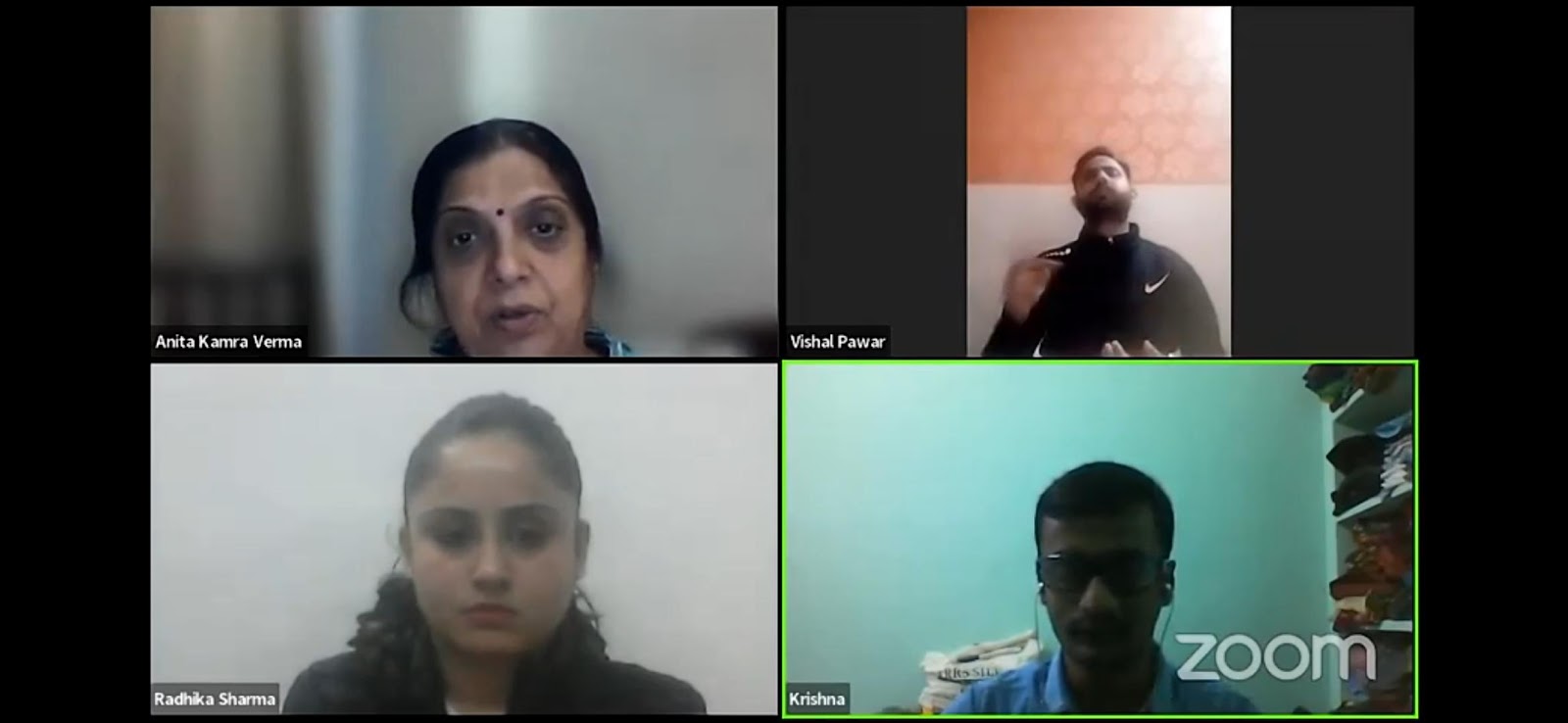 A Zoom meeting with four participants: Anita Kanra Verma, Vishal Pawar (signing), Radhika Sharma, and Krishna, each in their own video panel against varied indoor backgrounds.