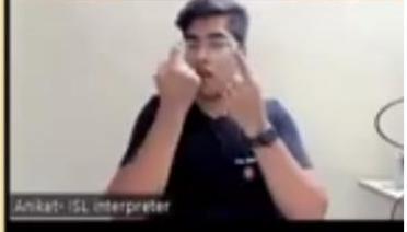 A young man with dark hair, labeled "Aniket - ISL Interpreter," is shown in a video call frame, actively signing with both hands raised towards his face.