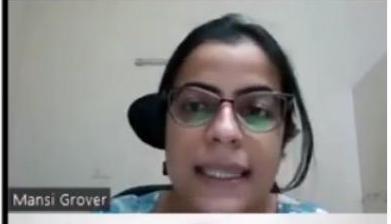 A woman named Mansi Grover, wearing glasses, is captured in a video call frame, looking forward with her mouth slightly open as if speaking.
